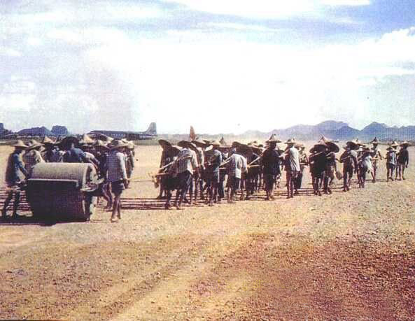 people pulled a big stone roller to built the Yangtang Airport in Guilin 